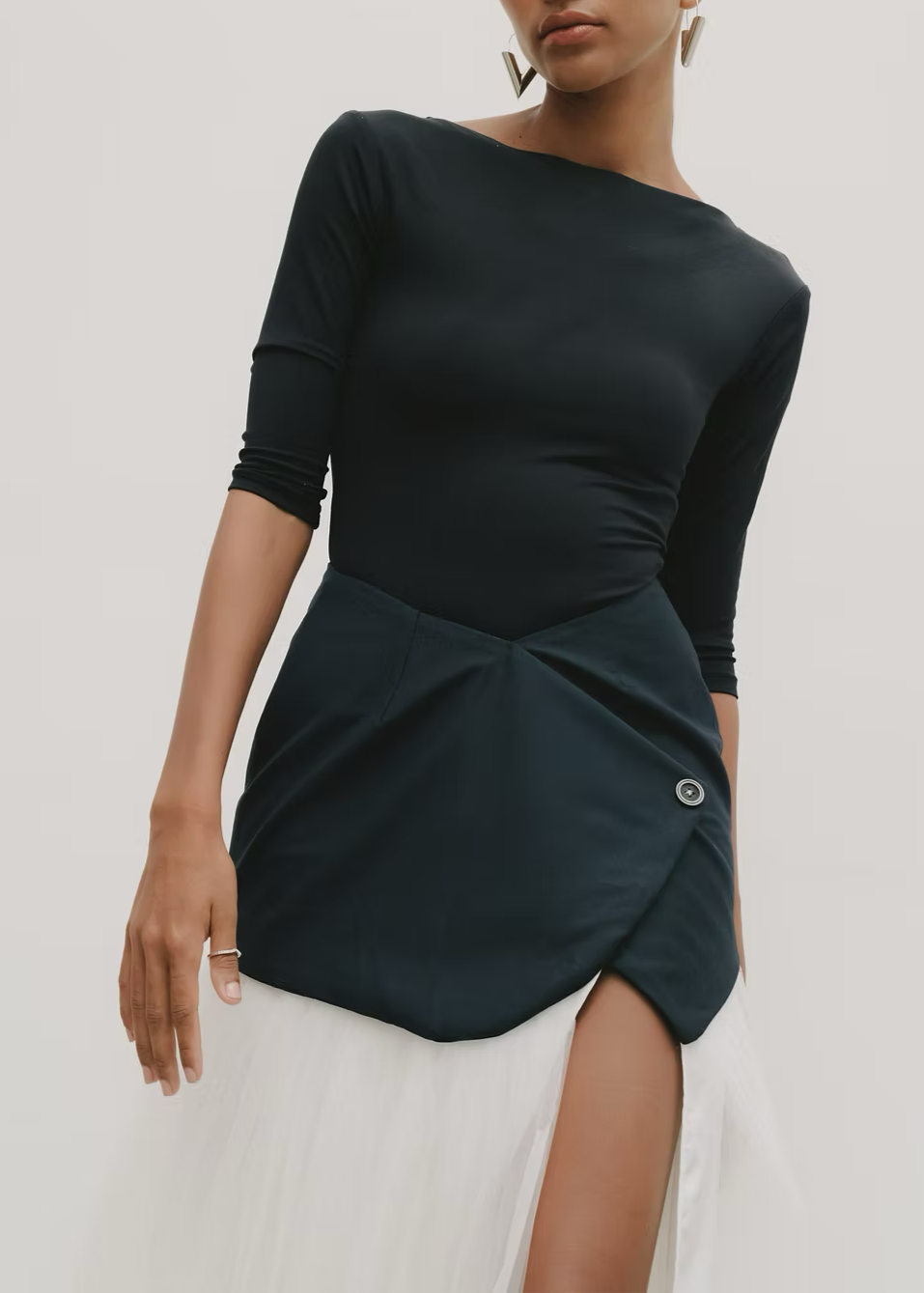 woman wearing a Black top and white skirt with a unique design on a white background