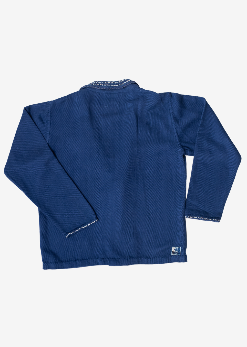 A dark blue long-sleeve jacket shown from the back, featuring a simple collar and subtle white contrast stitching along the edges, photographed against a light gray background.