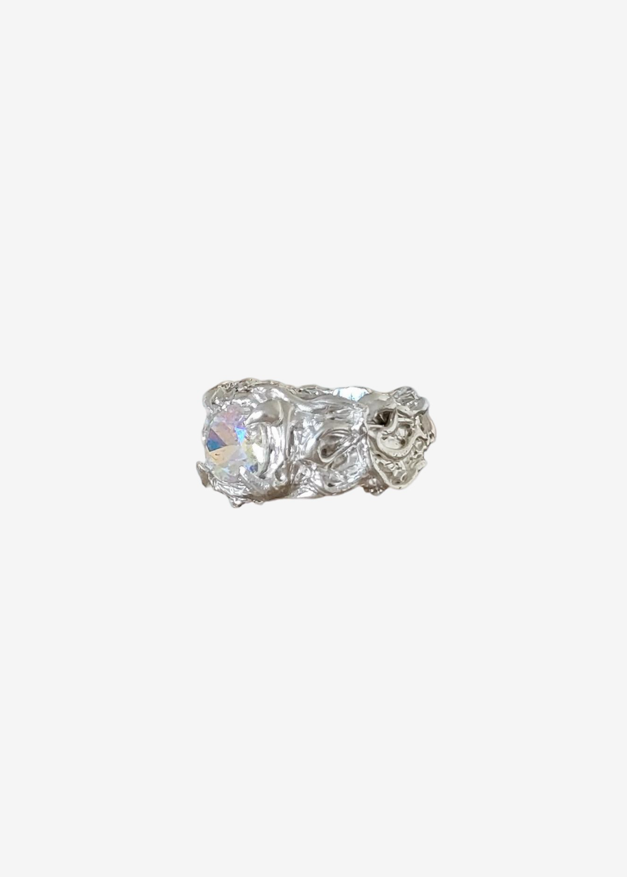 Silver ring with a large diamond on a white background