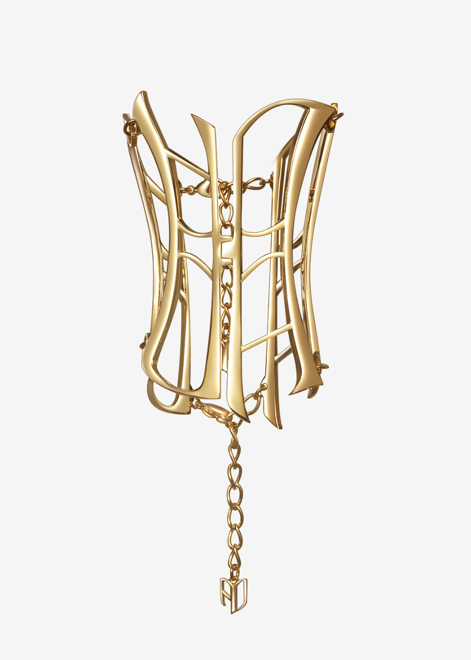 A gold-toned sculptural cuff bracelet with an open, corset-like geometric structure and hanging chains, shown against a plain light gray background.