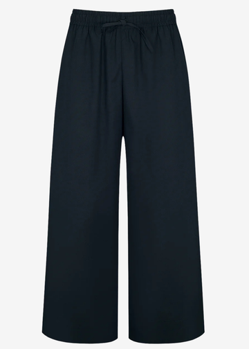 A pair of wide-leg cropped pants in a solid dark navy blue, featuring an elastic waistband with a drawstring, shown against a plain light gray background.