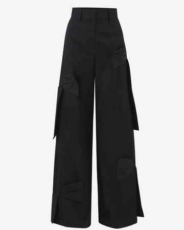 Black wide-leg cargo pants with large structured flap pockets on the sides and lower legs, shown against a plain light gray background.