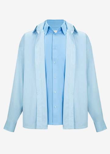A light blue long-sleeve button-up shirt with a relaxed, oversized fit, shown against a plain white background.