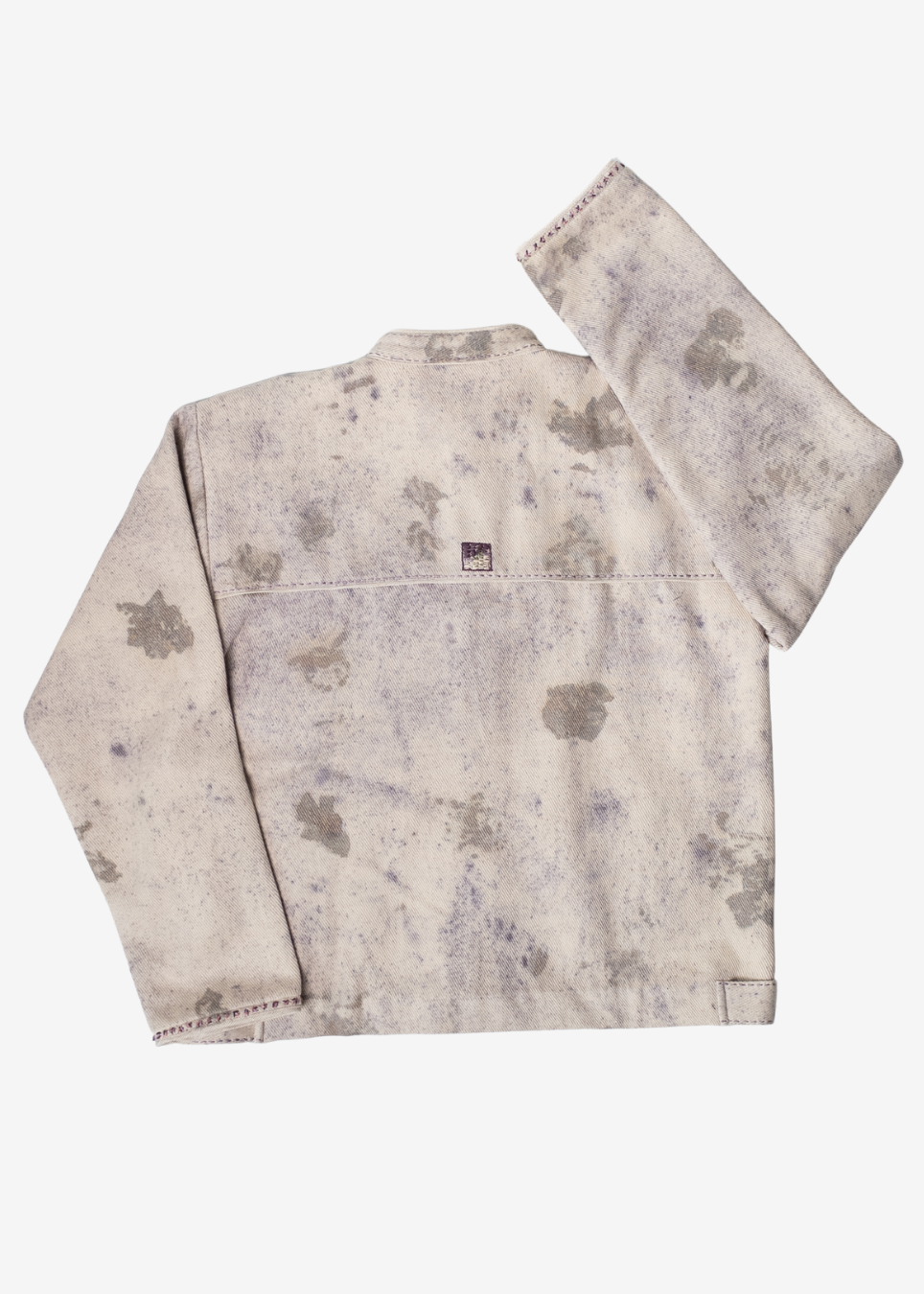 A long-sleeve denim jacket with a distressed, acid-washed finish in beige and gray tones, laid flat against a light gray background.