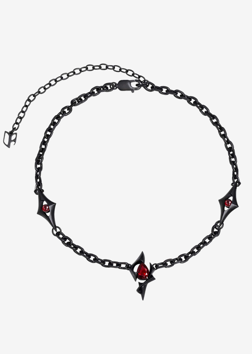 A gothic-style black metal chain necklace featuring three bat-shaped charms, each adorned with a small red gemstone, and a central spade-shaped pendant with a red teardrop gemstone, displayed on a light gray background.