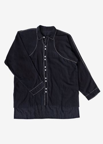 A dark midnight black long-sleeve button-up shirt with white contrast stitching and white buttons, laid flat against a light gray background.