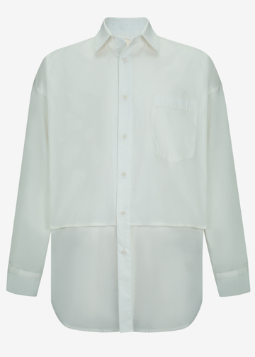 A long-sleeve button-up shirt in a very pale off-white or cream color, featuring a classic collar, a chest pocket, and a unique two-tone layered hem design, shown against a plain light gray background.