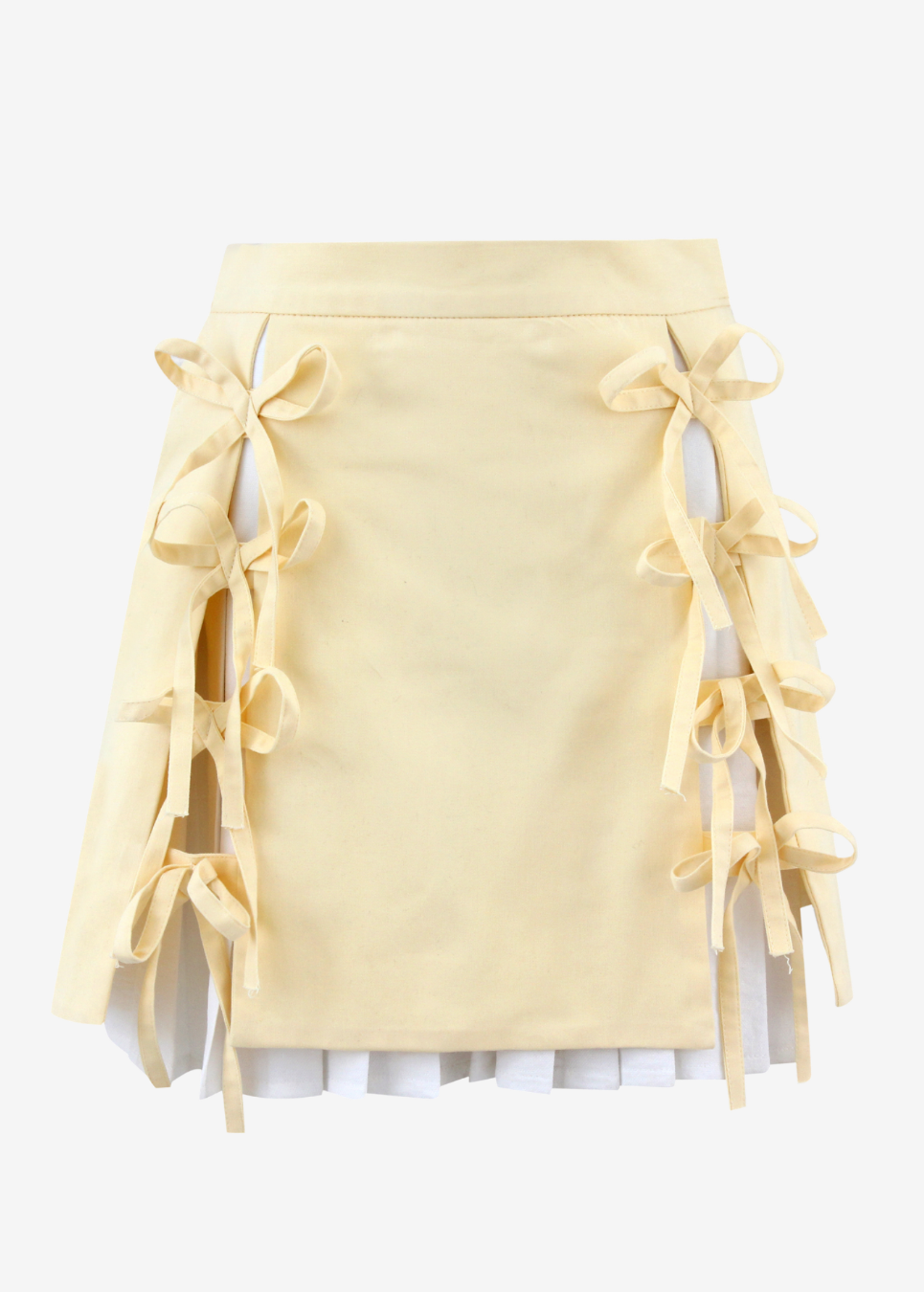 A pale yellow mini skirt with side tie-front details and layered ruffle trim, shown against a plain light gray background.